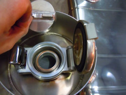 Secondary screw cap to create one way valve to meet blue book